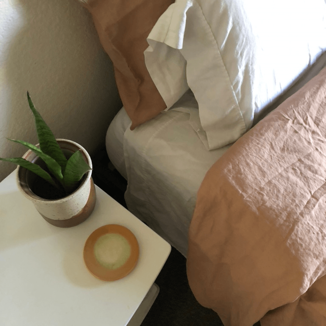 Terracotta colored coasters on a desk in a bedroom